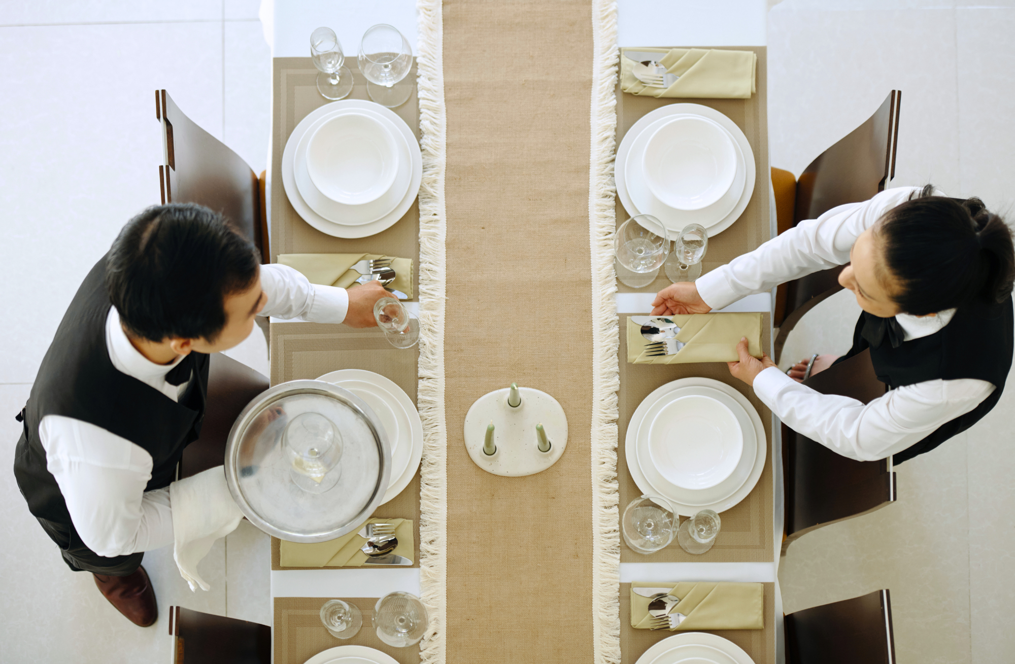 Commercial kitchen chefs preparing dishes behind the pass representing skilled migration hospitality in Australia